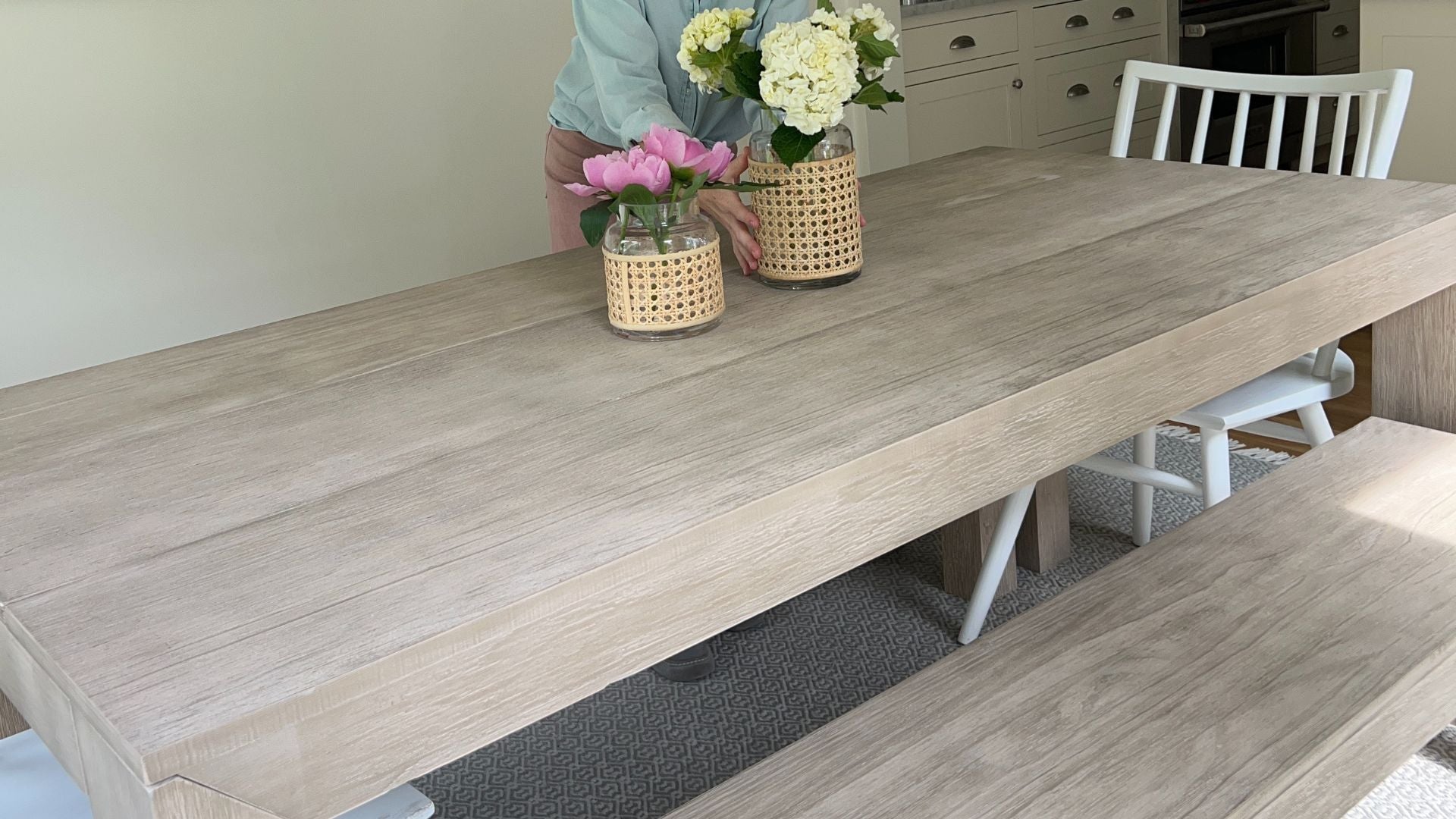 Modern Dining Table Set in Seashell with Two Dining Benches, White Dining Chair, and Floral Centerpieces